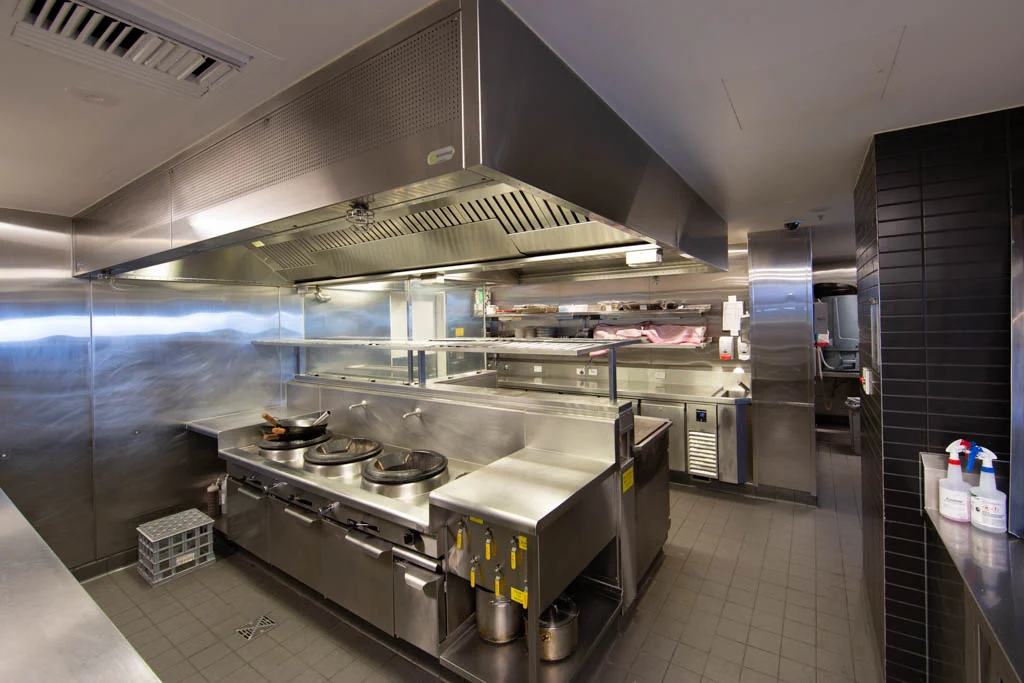 Stainless-steel commercial kitchen equipment and ventilation hood